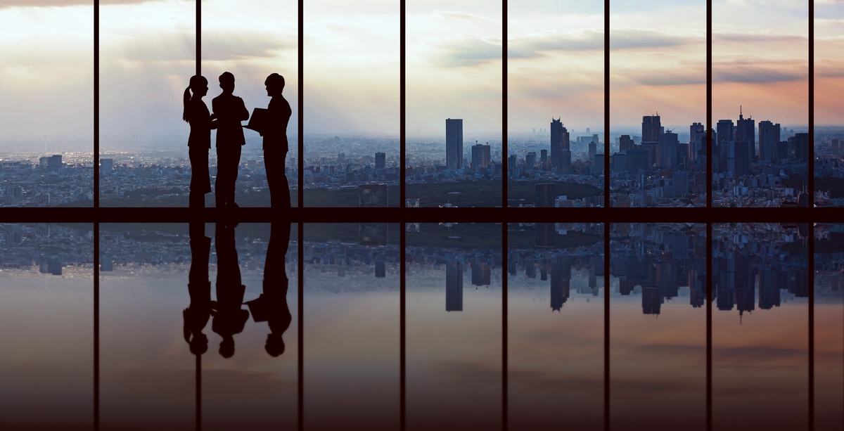 Businesspeople in front of urban cityscape.