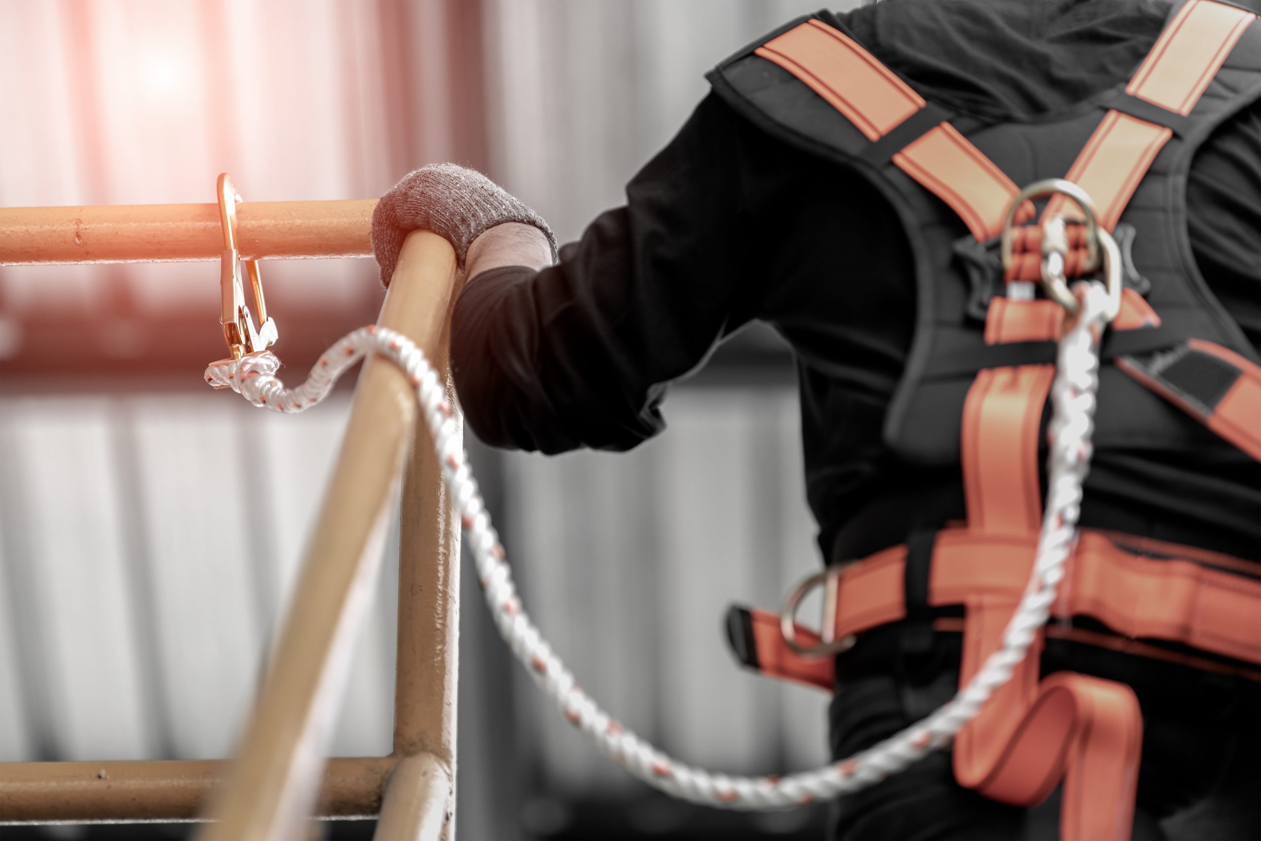 Worker wearing safety harness.