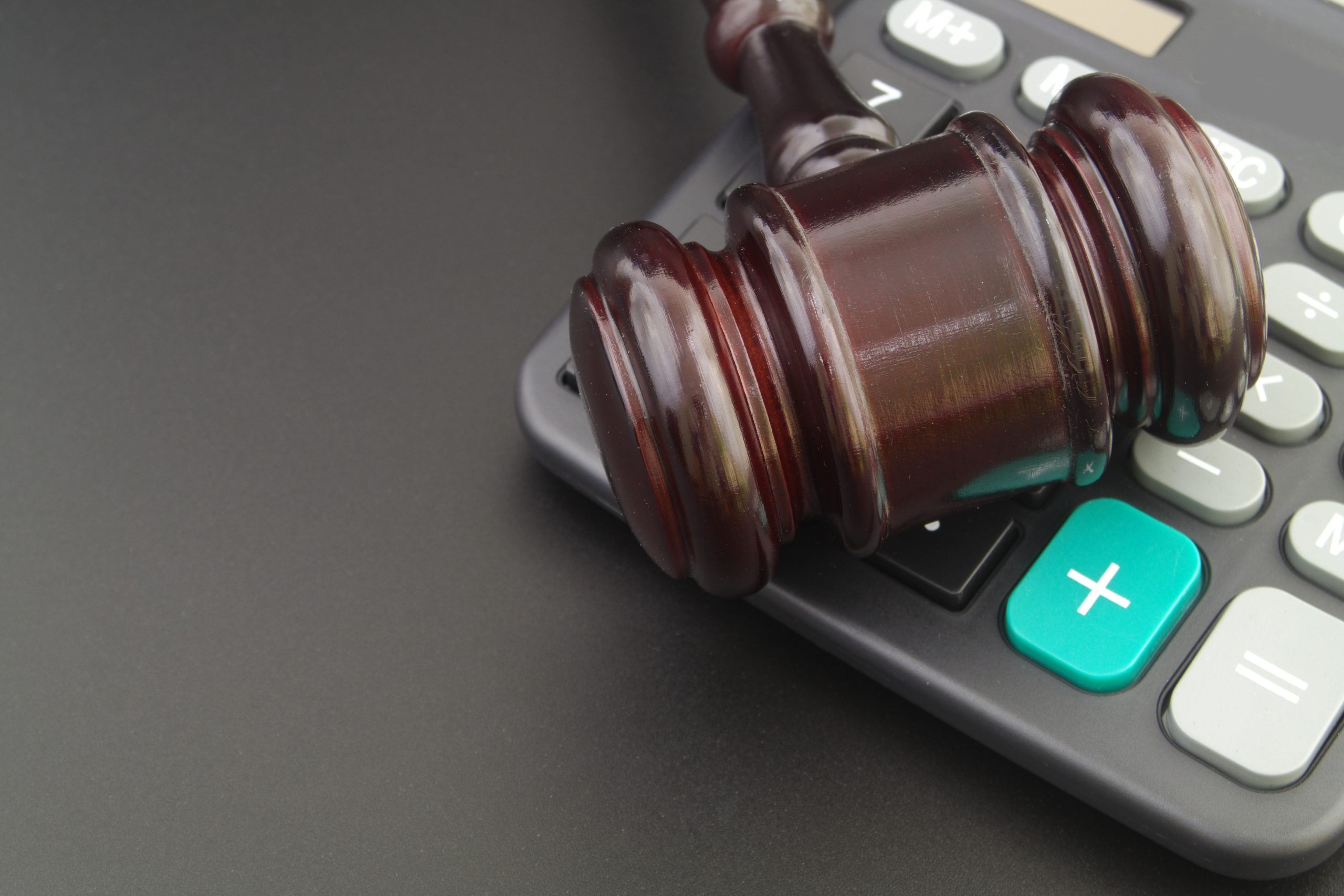 Judge gavel and calculator, arbitrage concept.