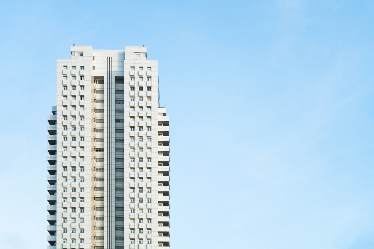 White modern skyscraper perfect symmetry with blue sky and copy space