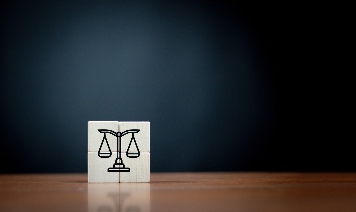 law flat icon on cube block on wooden table over dark background .