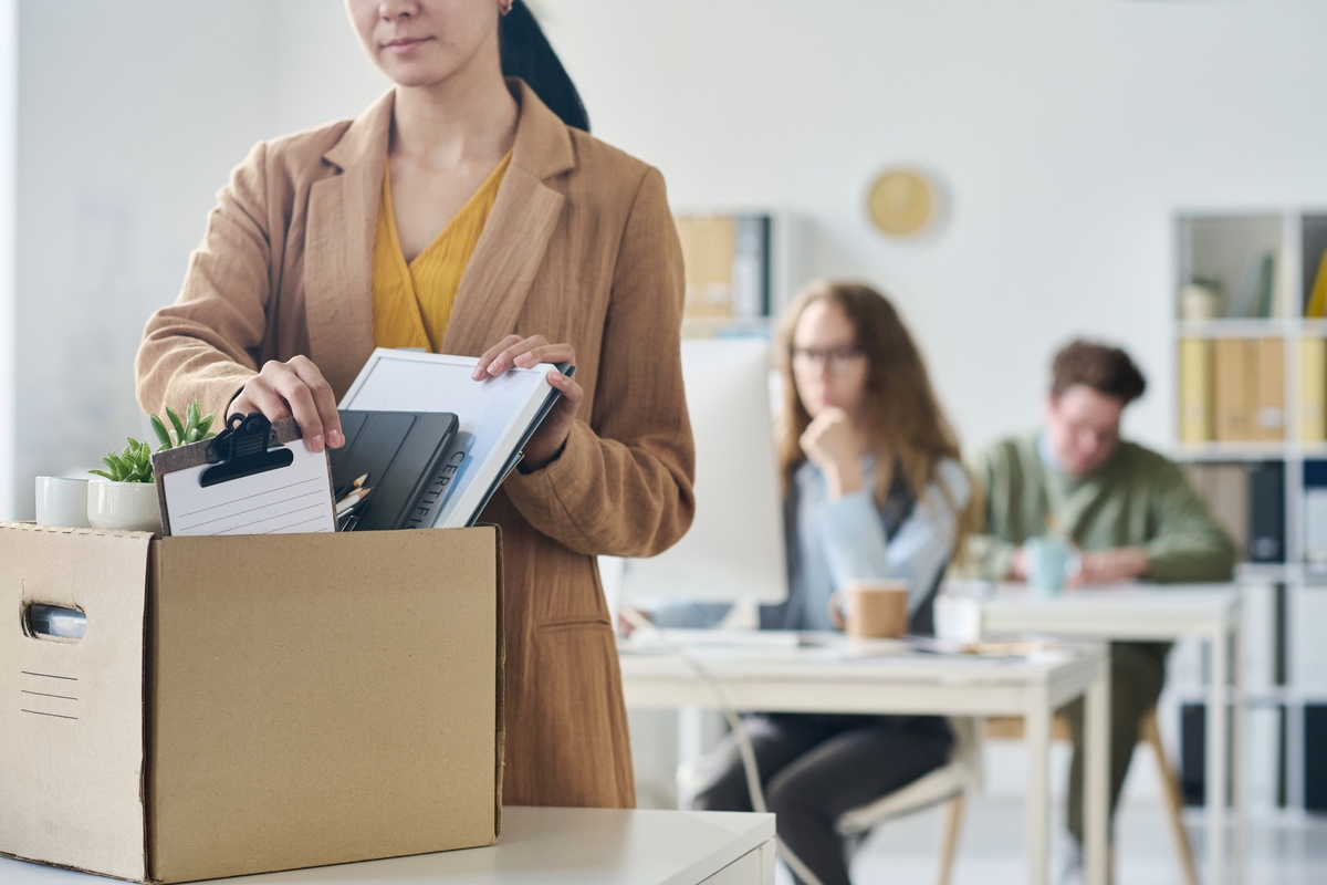 Businesswoman packing her things in box in office
