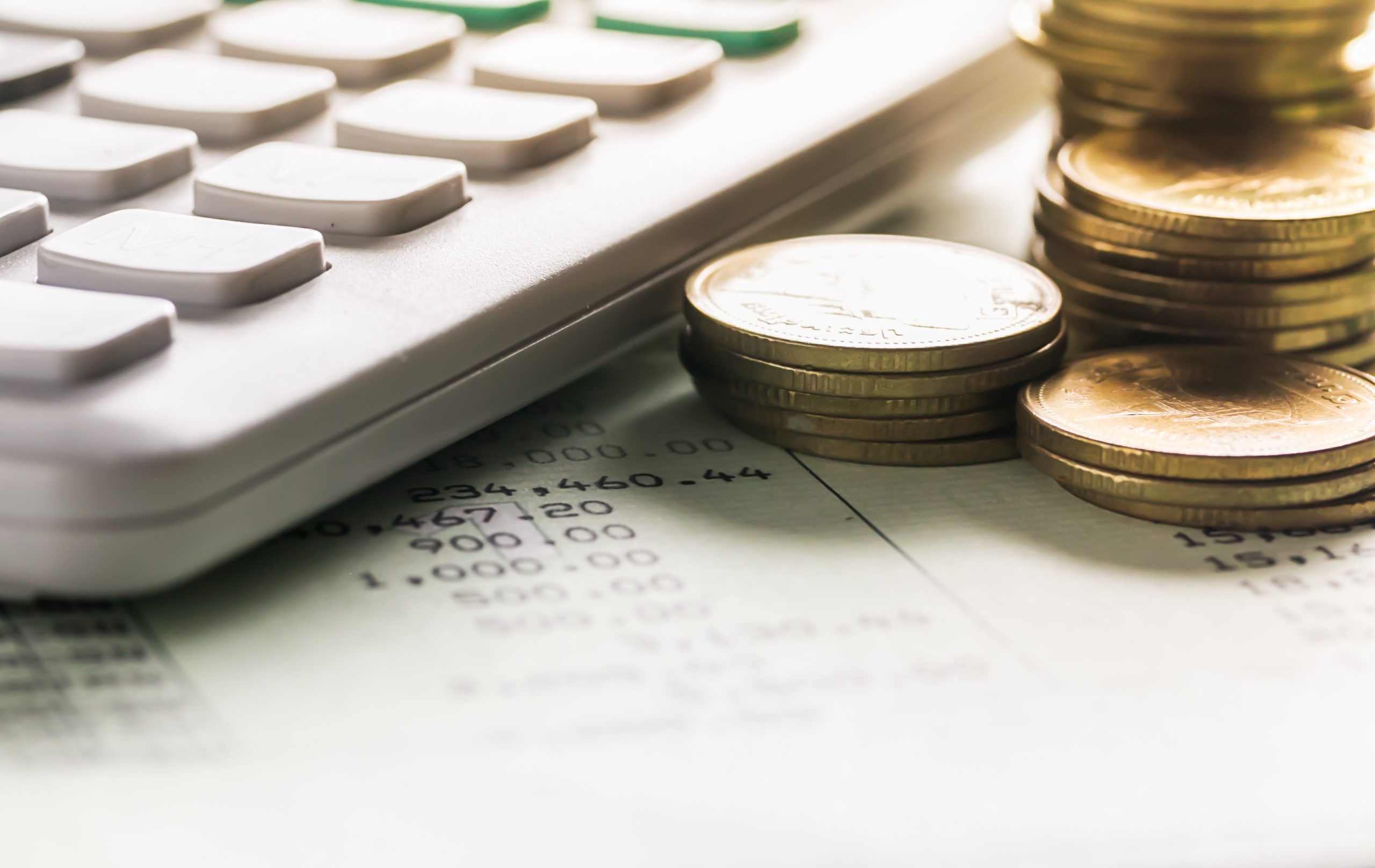 Gold coins with calculator on book bank