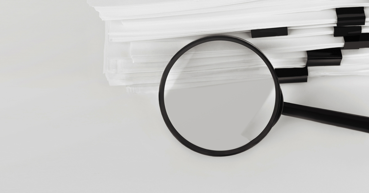 stack-report-paper-documents-with-magnifying-glass-concept-business-search_2